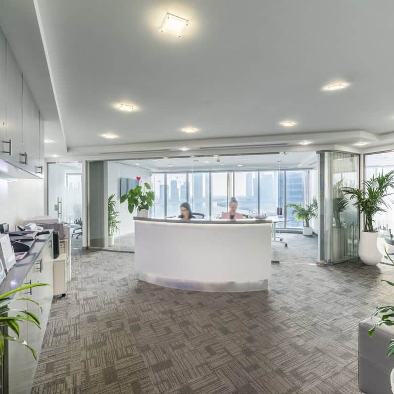 Modern coworking and shared workspace in Dubai with city skyline view.