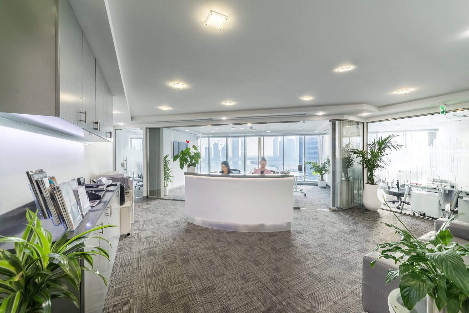 Modern coworking and shared workspace in Dubai with city skyline view.