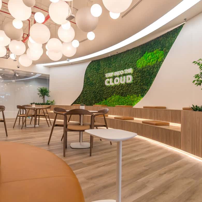 Bright, contemporary coworking environment with plants and ambient lighting.