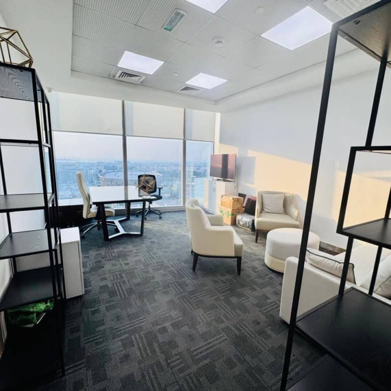 Spacious, bright workspace with stylish furniture and panoramic city skyline views in Dubai UAE.