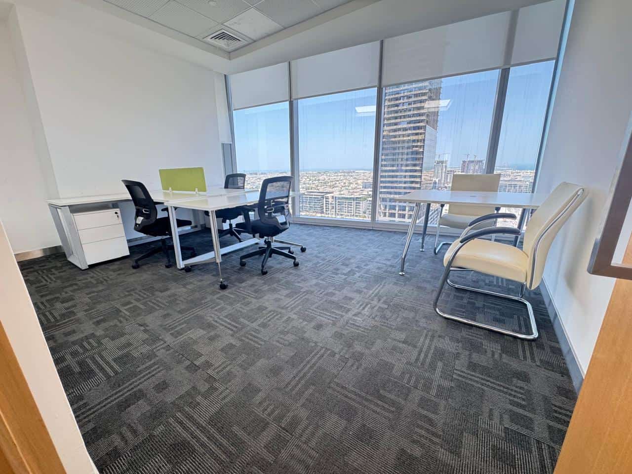 Bright coworking office in Dubai featuring panoramic city views and ergonomic furniture.