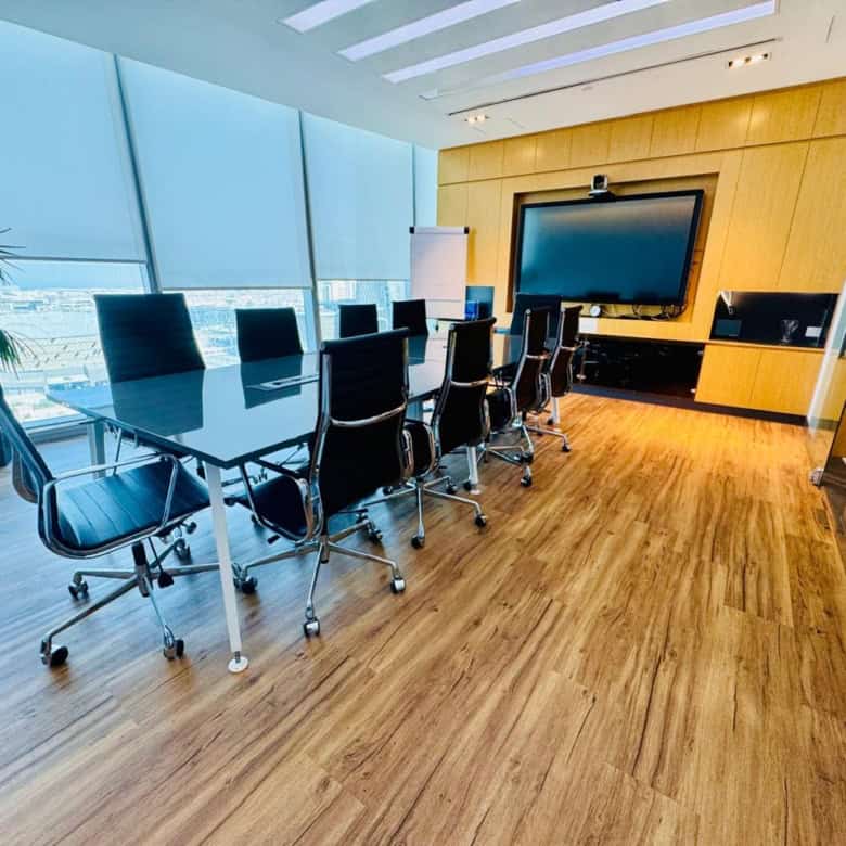 Spacious UAE coworking space with large screen and comfortable chairs for productive meetings.