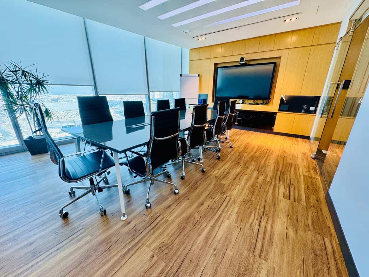 Spacious UAE coworking space with large screen and comfortable chairs for productive meetings.