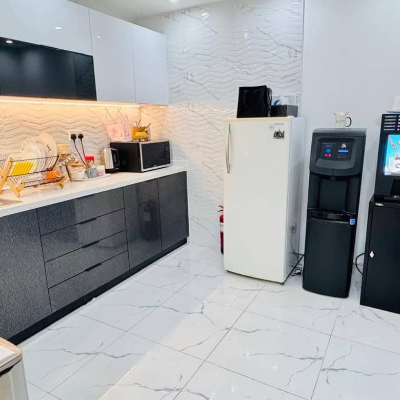Office kitchenette with appliances, microwave, water cooler, coffee machine in Dubai.