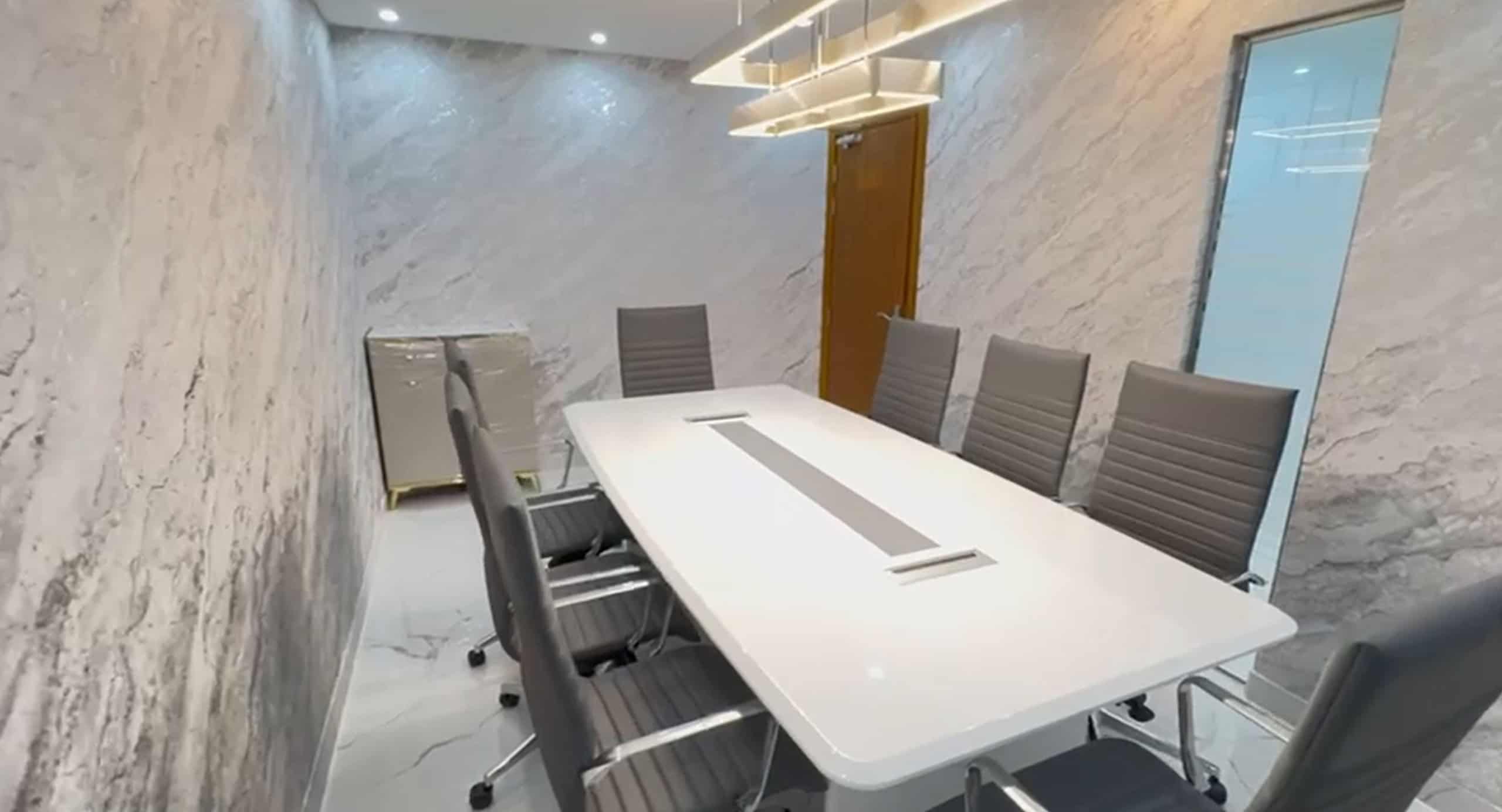 Comfortable conference room with ergonomic chairs and marble walls in Dubai.
