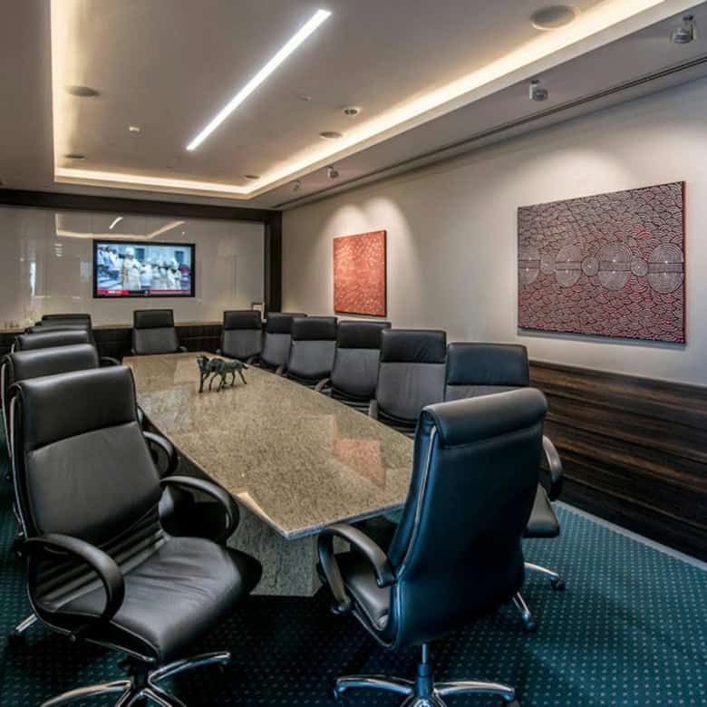Luxurious office meeting room at Nextspace UAE, featuring black leather chairs and stylish decor.