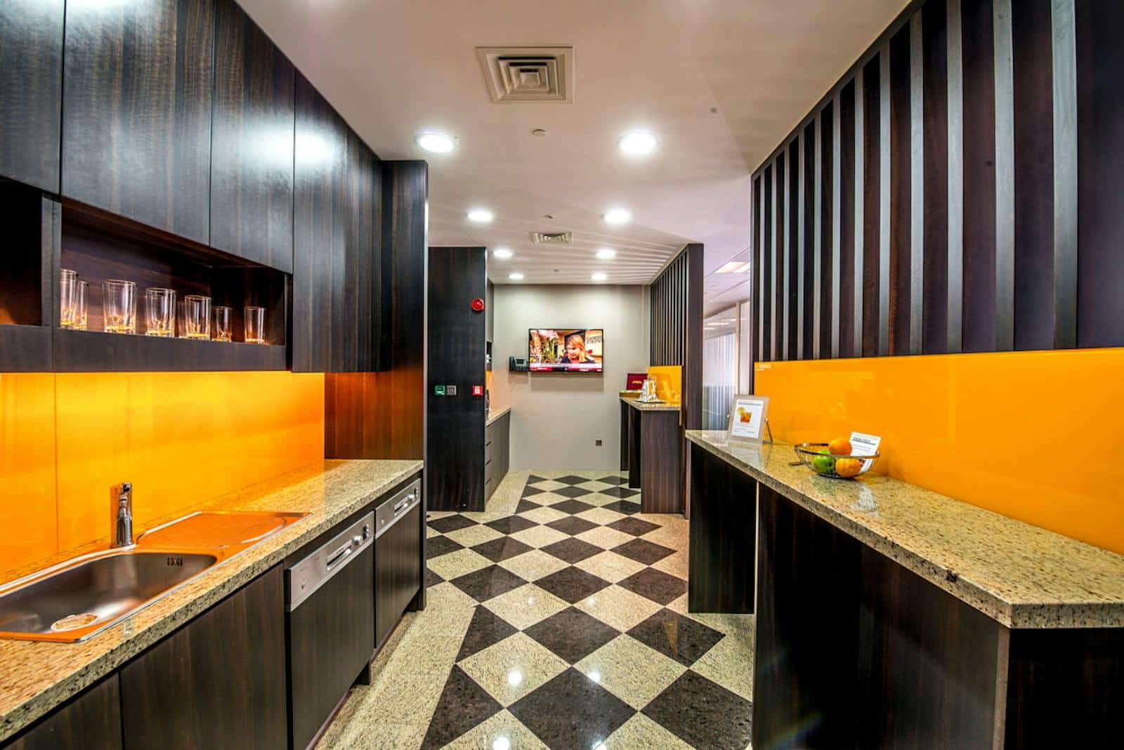 Bright indoor workspace with kitchenette and colorful decor at Nextspace UAE coworking hub.