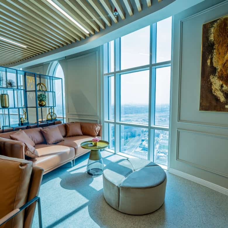 Modern coworking space with stylish seating and large windows in UAE.