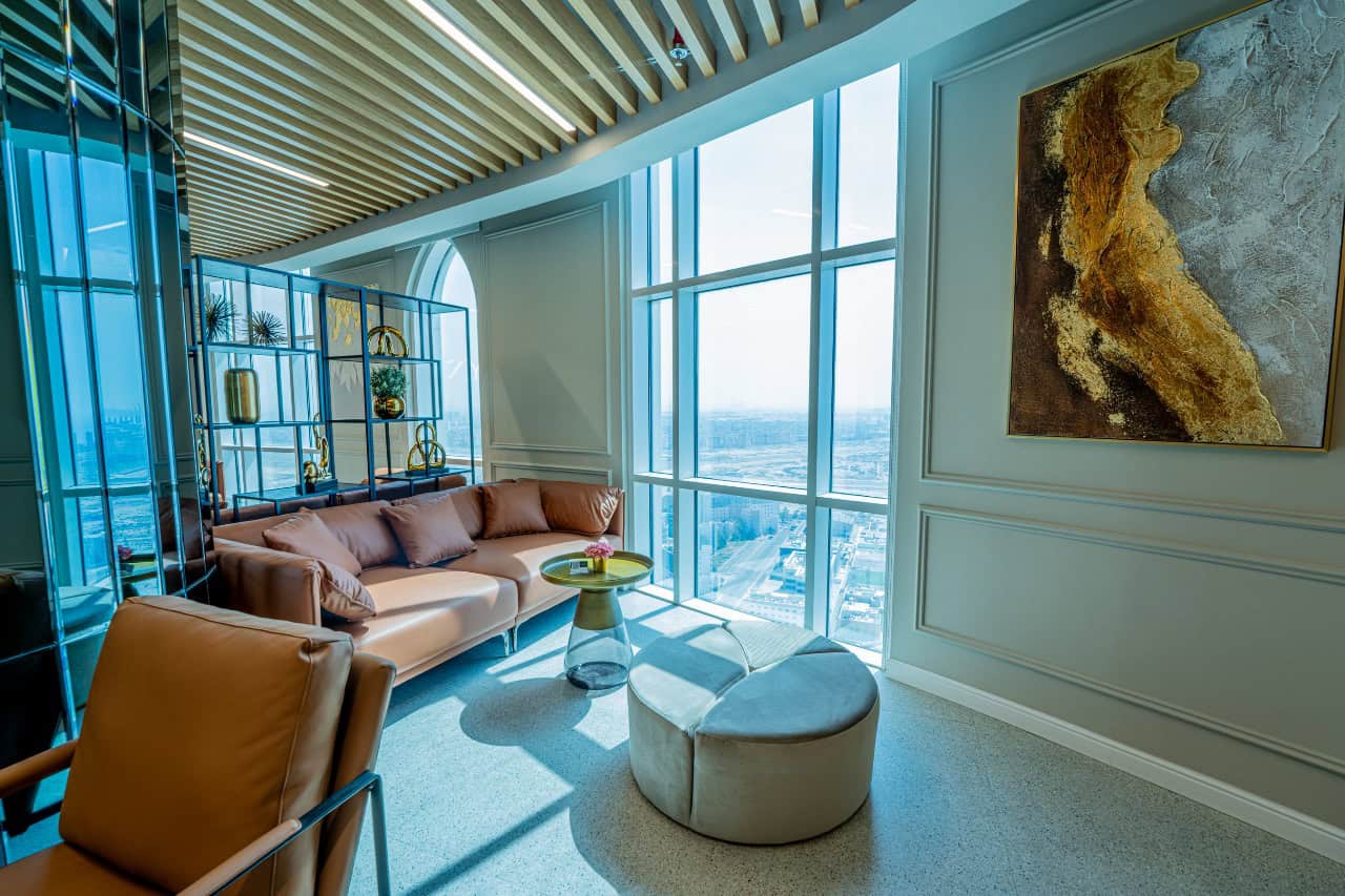 Modern coworking space with stylish seating and large windows in UAE.