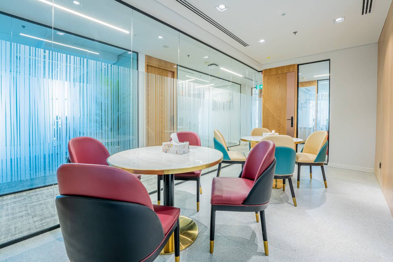 Bright, stylish coworking environment with vibrant chairs and contemporary decor in Dubai UAE.