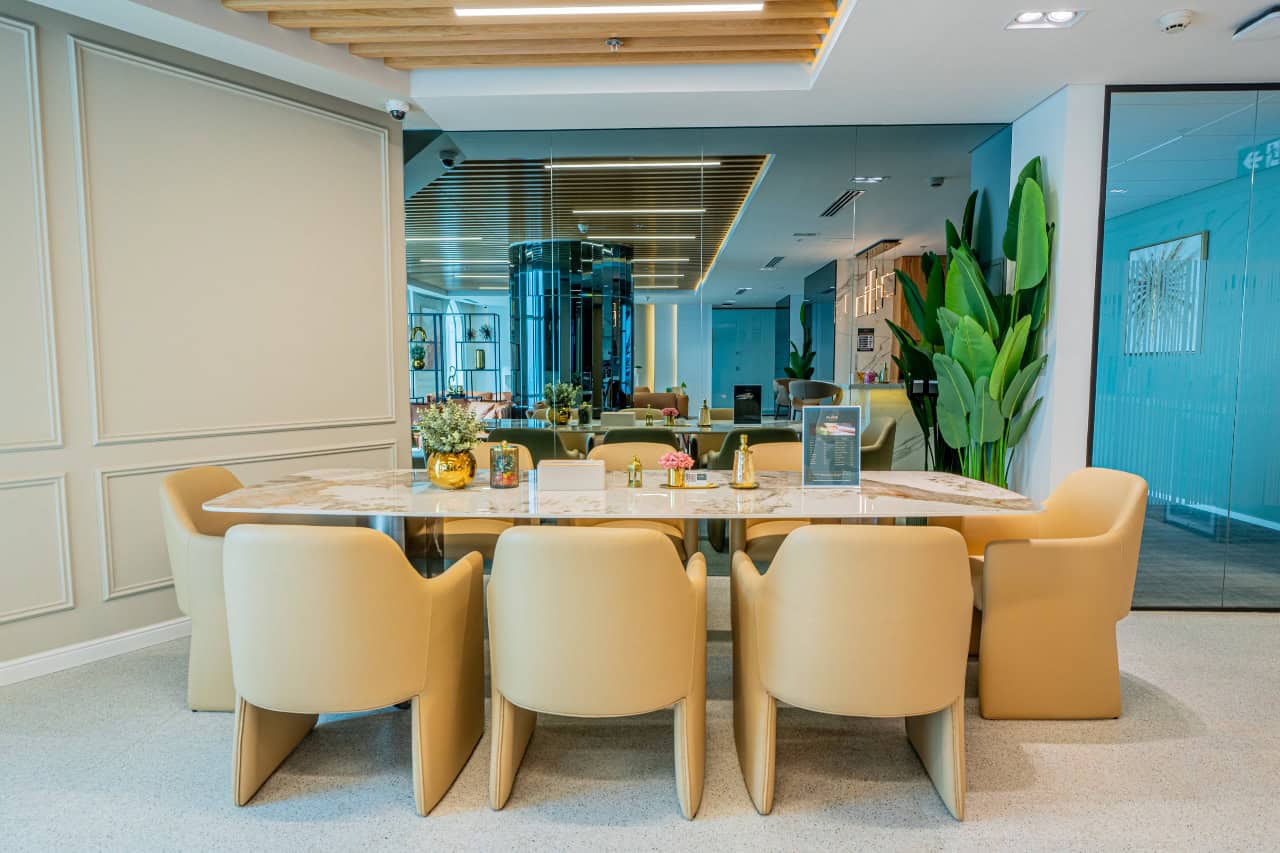 Bright, stylish office conference area with contemporary furniture and greenery in Dubai, UAE.