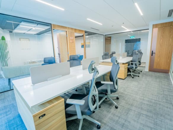Bright, collaborative coworking space in Dubai, featuring modern office furniture and private meeting rooms.