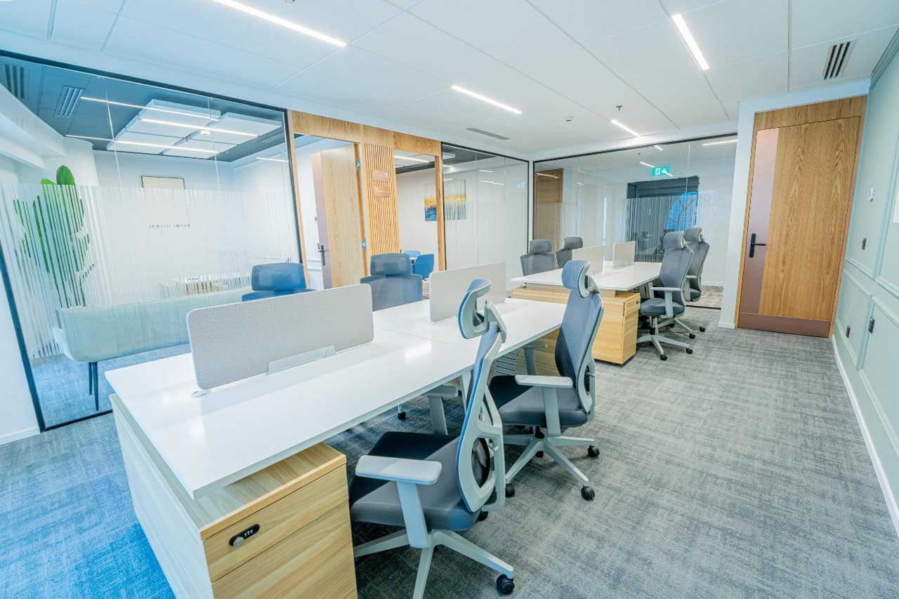 Bright, collaborative coworking space in Dubai, featuring modern office furniture and private meeting rooms.