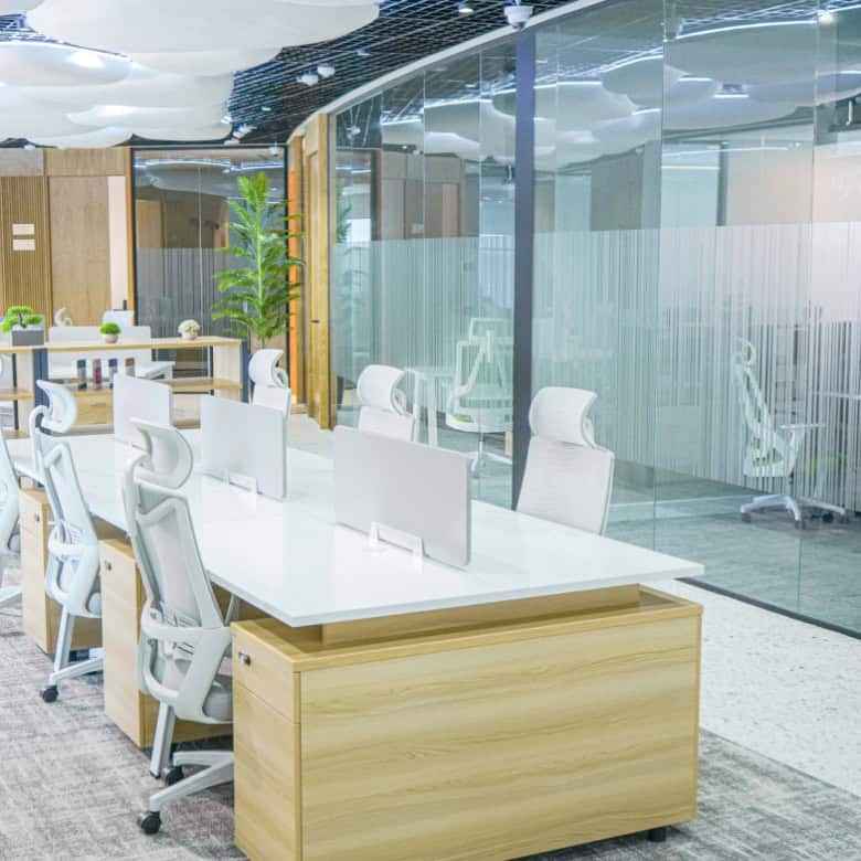 Bright office interior with open workstations and glass partitions in Dubai.