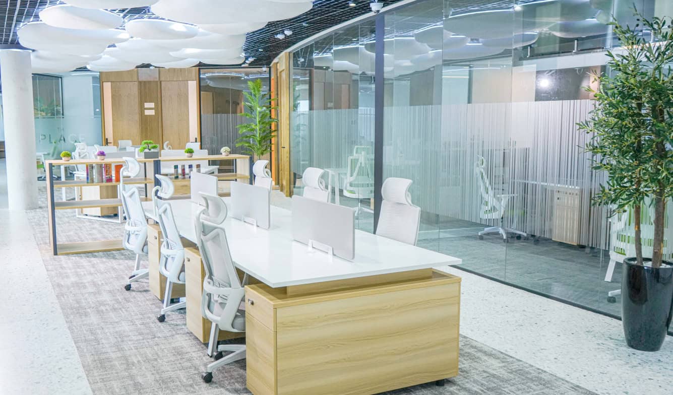 Bright office interior with open workstations and glass partitions in Dubai.