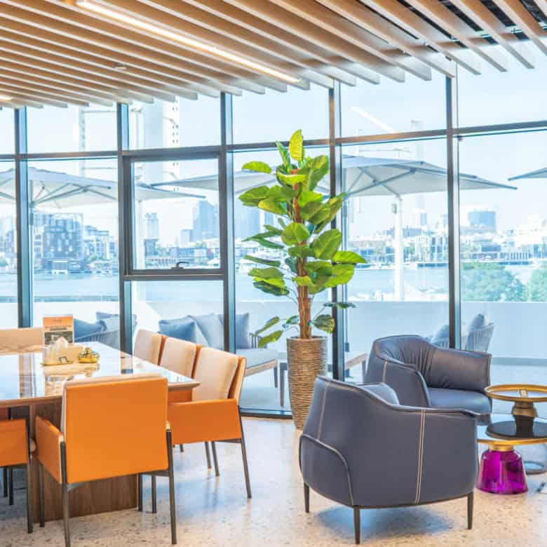 Bright, stylish coworking space with large windows and comfortable seating in Dubai UAE.
