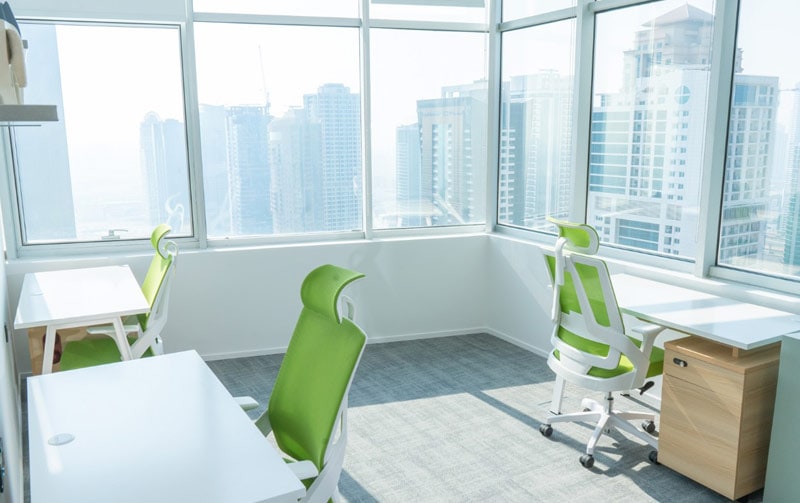 Bright modern coworking space in Dubai with ergonomic chairs and city views.