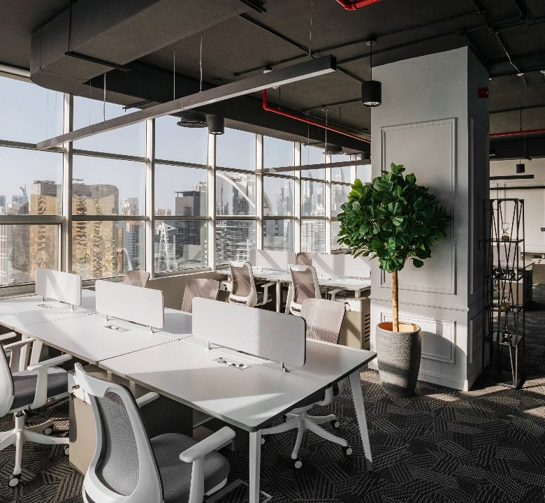 Modern coworking office in Dubai with large windows and collaborative workspaces.