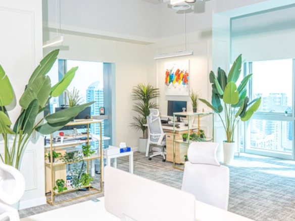 Bright, airy office with plants and contemporary furnishings in Dubai UAE.
