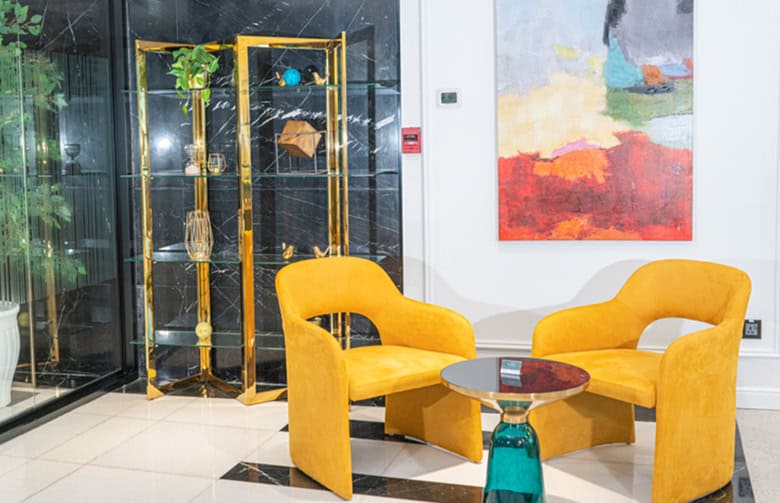 Modern coworking lounge with vibrant yellow armchairs and stylish decor in Dubai office space.