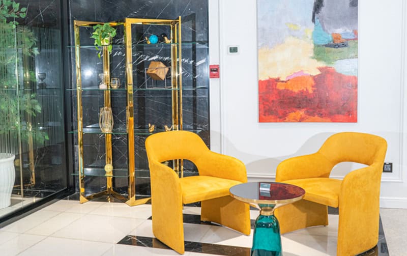 Modern coworking lounge with vibrant yellow armchairs and stylish decor in Dubai office space.