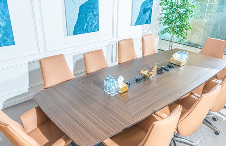 Spacious Nextspace UAE conference room featuring a large meeting table and comfortable leather chairs.