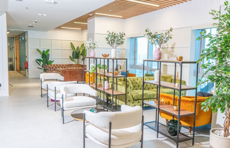 Modern coworking space in Dubai, UAE with stylish seating and vibrant decor.