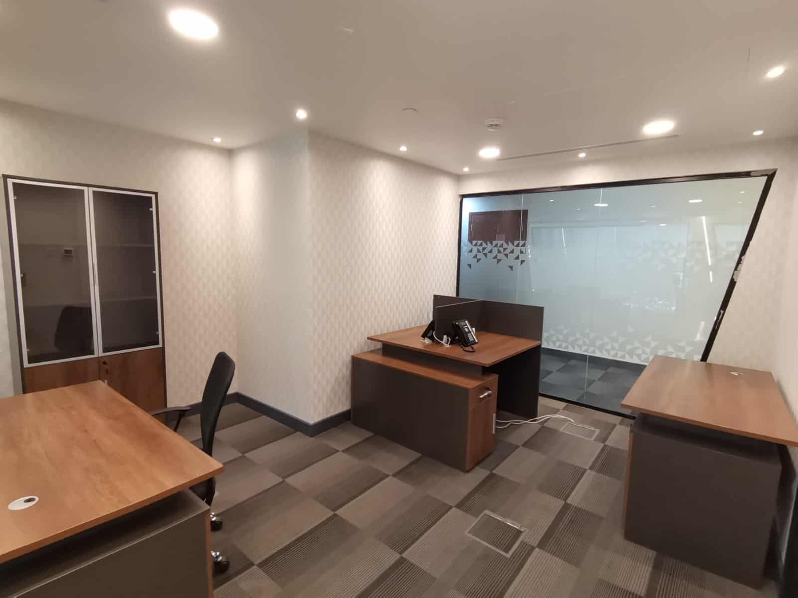 Bright office interior with modern furniture and glass partition wall, ideal for business collaboration.