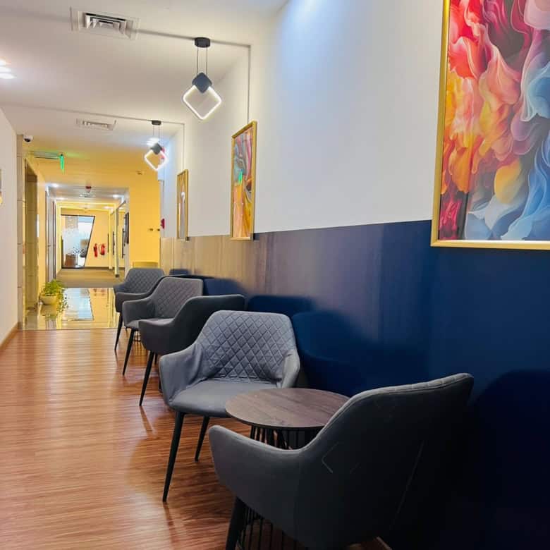 Comfortable seating with stylish art decor at Nextspace UAE coworking lounge.