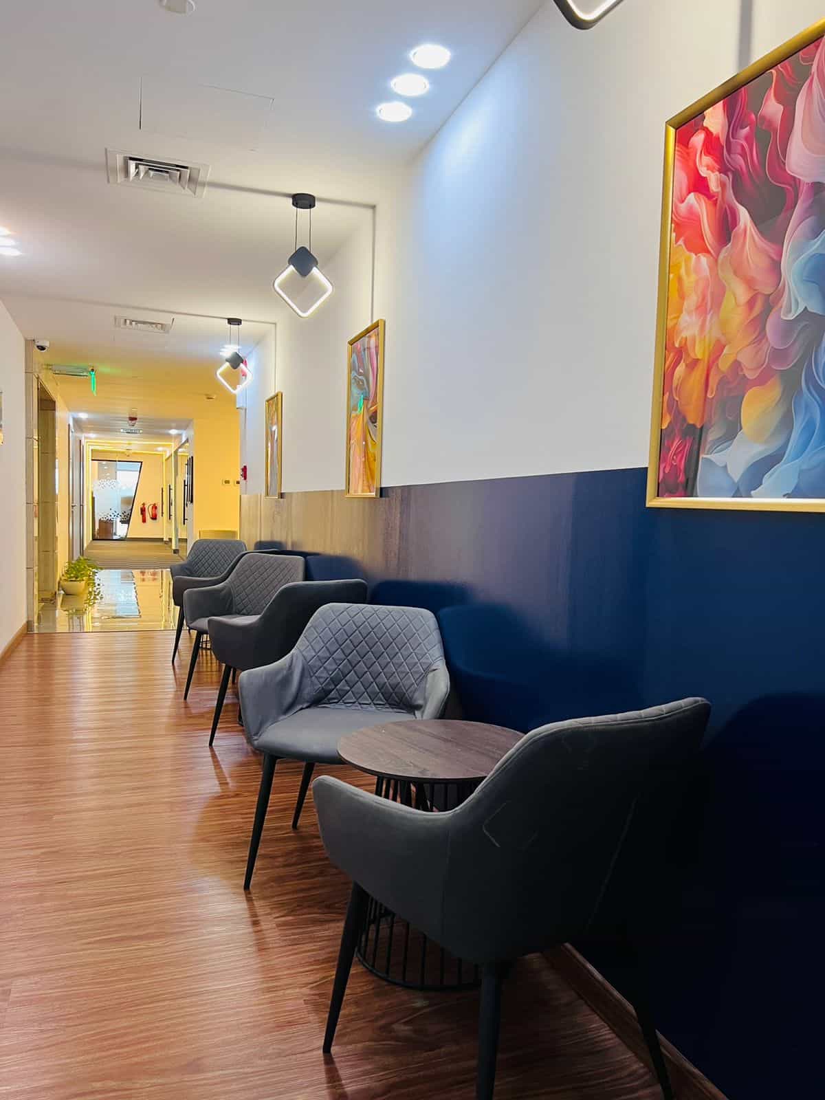 Comfortable seating with stylish art decor at Nextspace UAE coworking lounge.