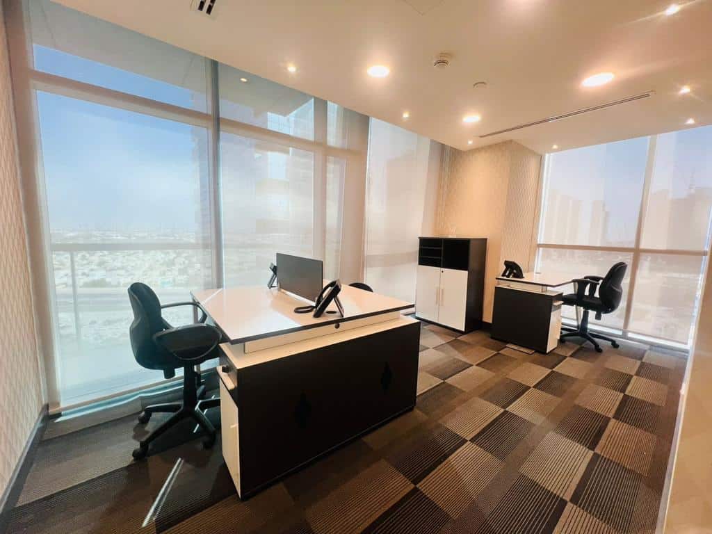 Bright office with contemporary furniture and panoramic city views, ideal for remote work and meetings.