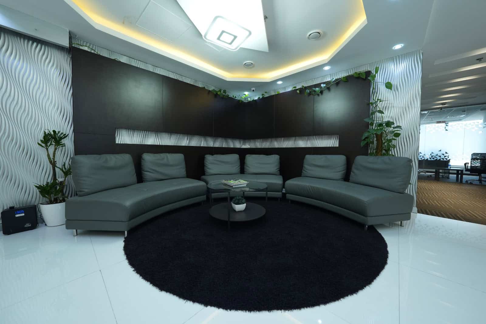 Comfortable coworking lounge in Dubai featuring stylish gray seating and modern design.