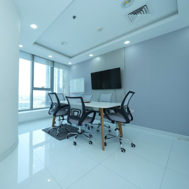 Bright coworking space in Dubai with sleek furniture and large windows for productivity and collaboration.