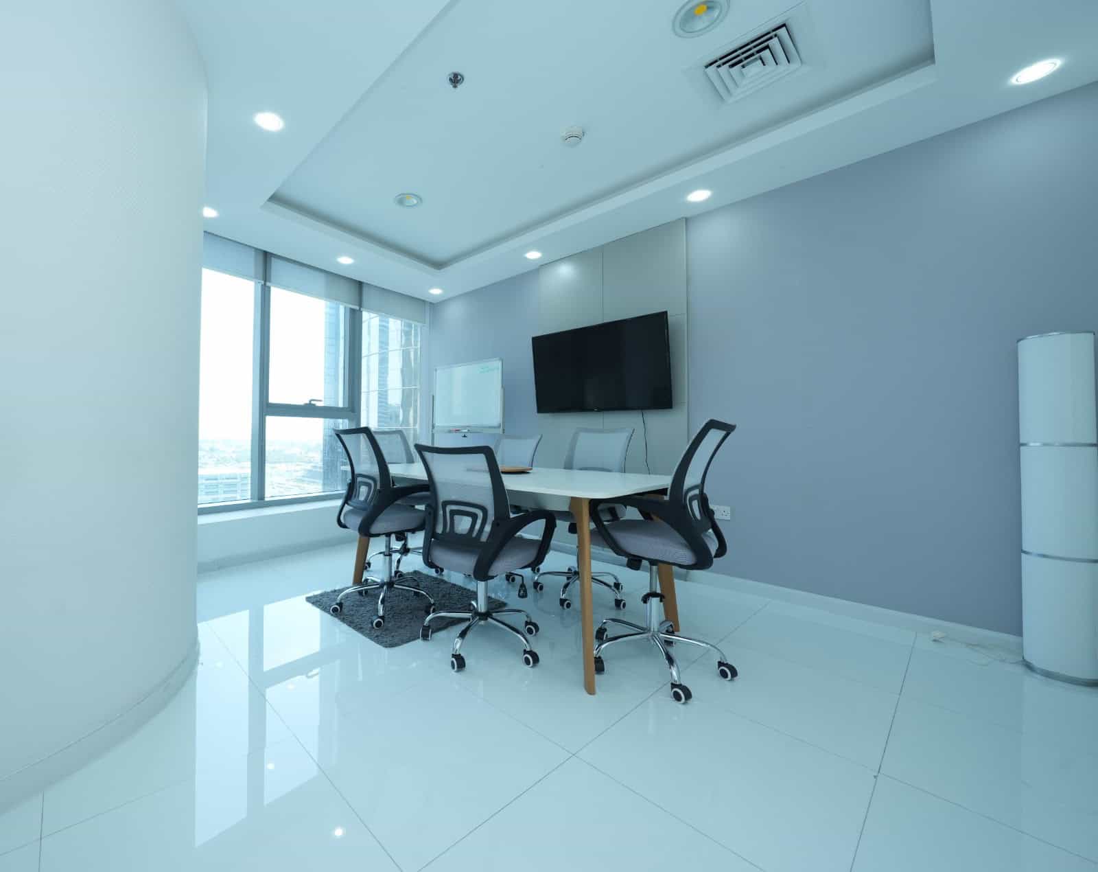 Bright coworking space in Dubai with sleek furniture and large windows for productivity and collaboration.