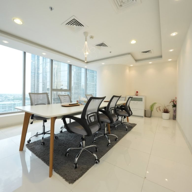 Bright, professional meeting room with ergonomic chairs and large windows.