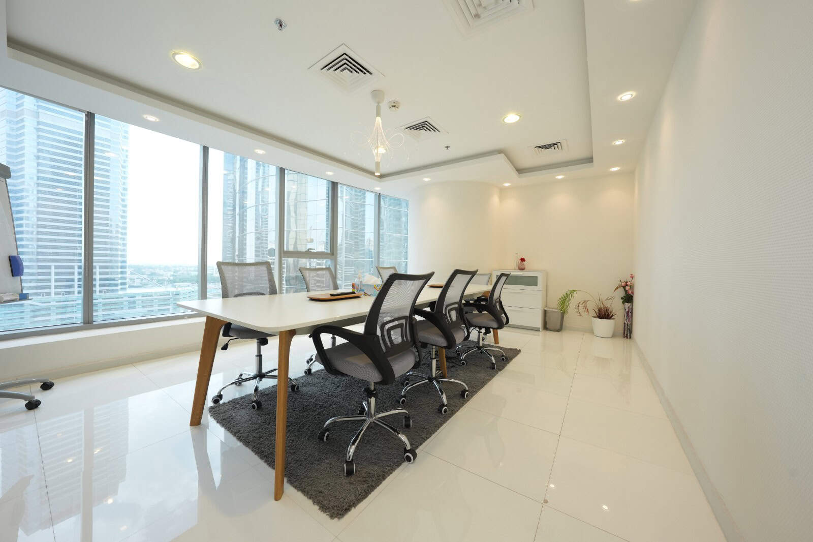 Bright, professional meeting room with ergonomic chairs and large windows.