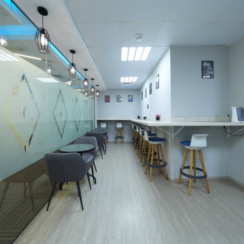 Contemporary coworking space interior in Dubai, UAE with stylish seating and workstations.