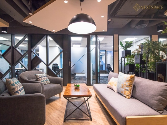 Co-working space in UAE with meeting room, TV display, and modern office amenities.