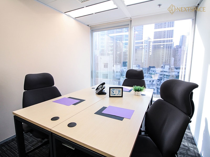 Bright, stylish workspace with modern furniture, kitchenette, and relaxing lounge area in UAE.