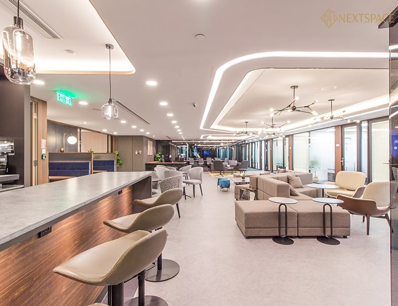 Bright Dubai coworking office with contemporary furniture and large windows.