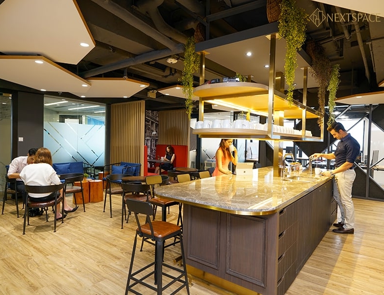 Spacious conference room with glass walls, comfortable chairs, and a large TV screen for meetings and collaborations.