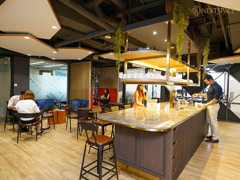 Spacious conference room with glass walls, comfortable chairs, and a large TV screen for meetings and collaborations.