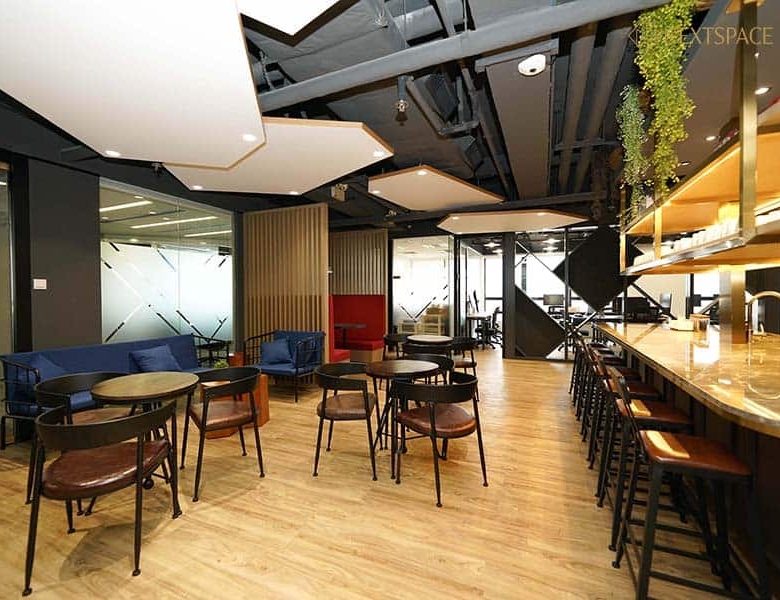 UAE coworking office with large windows, modern desk setup, and city skyline views.