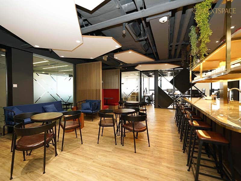 UAE coworking office with large windows, modern desk setup, and city skyline views.