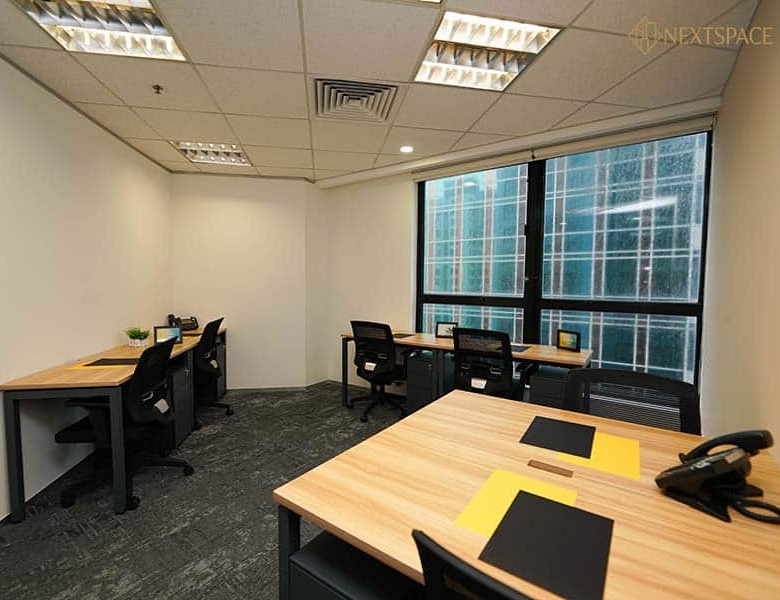 Bright office with large windows and ergonomic chairs in Dubai UAE.